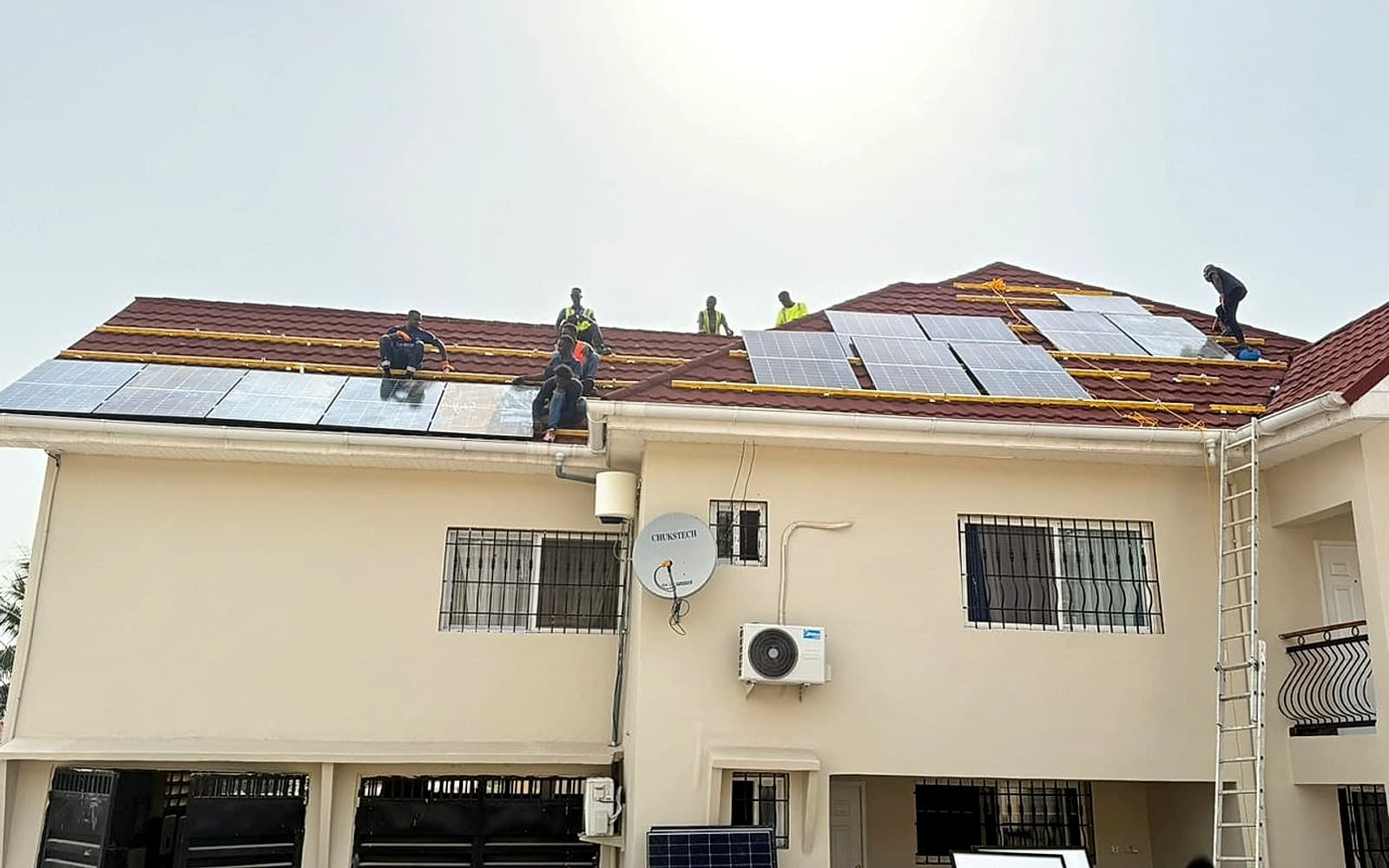 PKS team installing rooftop solar panels in Sierra Leone